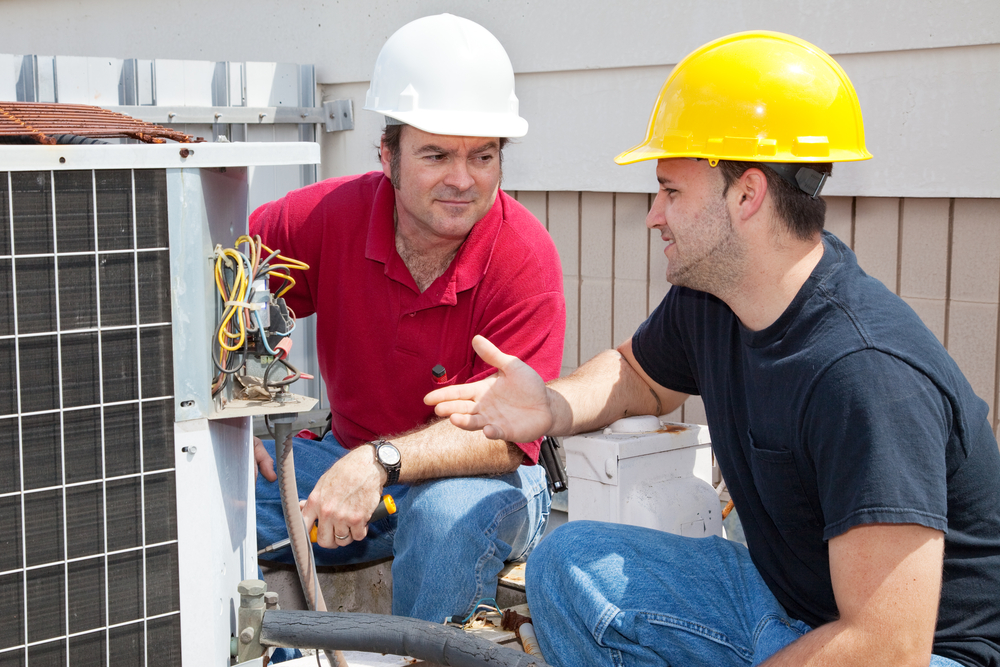 image of a heater repair persons installing an air conditioning system
